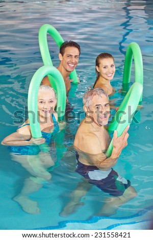 Happy group of people in aqua fitness class in swimming pool