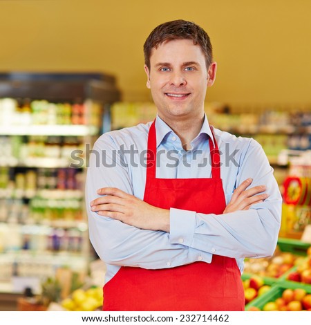 Portrait of happy retail salesman in a supermarket