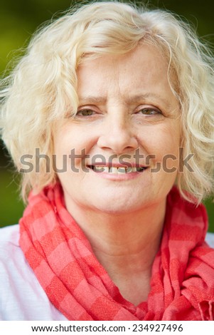Portrait of an old senior woman smiling outdoors