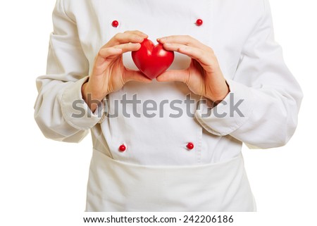 Chef cook holding a red heart in front of the workwear