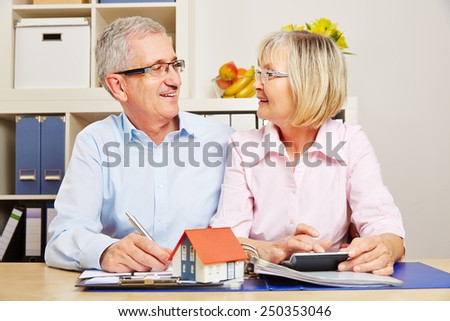 Happy senior couple planning mortgage financing together for building a house