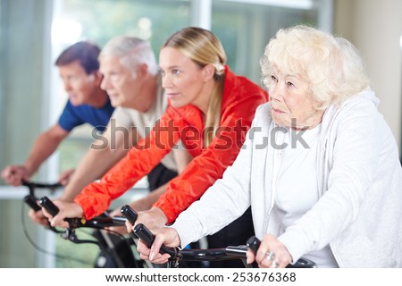 Senior group together in a spinning class in rehab care center