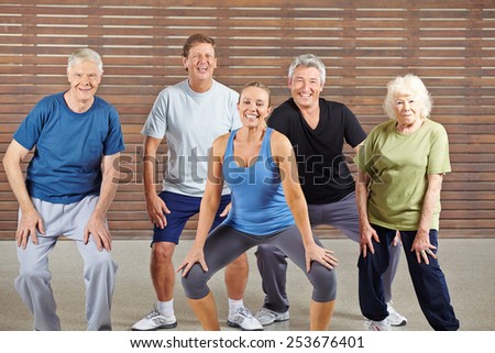 Happy senior group taking dancing lessons together in a gym