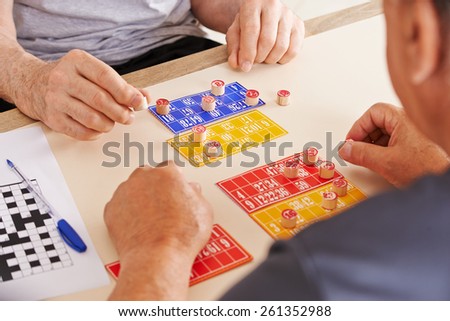 Old men playing Bingo together in a nursing home