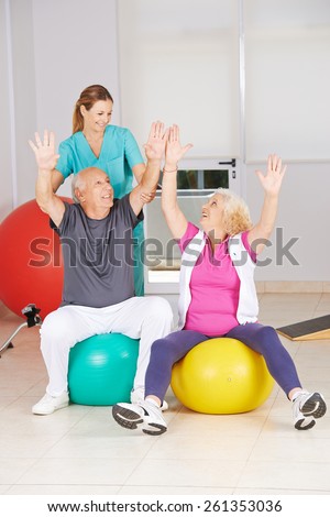 Two senior citizens doing sports in physiotherapy during rehab