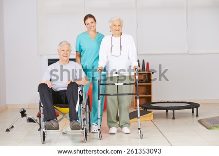 Two senior people with nurse during physiotherapy in a nursing home