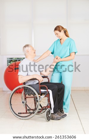 Old man in wheelchair at physiotherapy in a nursing home