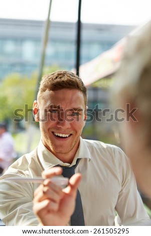 Young smiling business consultant giving advice to a customer