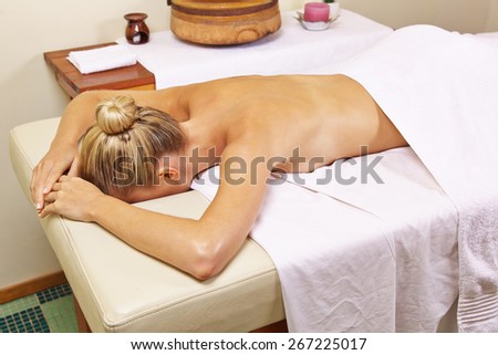 Young woman in health resort spa waiting for a back massage