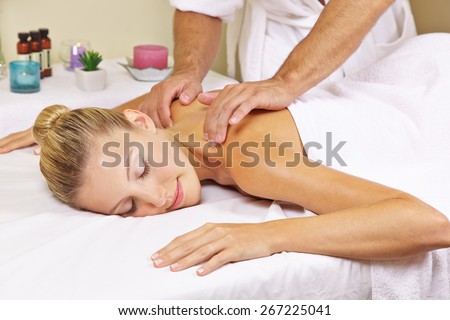 Woman receiving a nape massage in day spa from a masseur