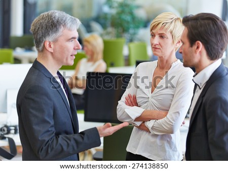 Business team communication in the office with elderly businessman talking