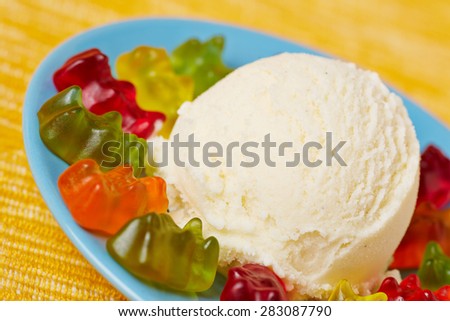 Colorful gummy bears with vanilla ice cream as dessert for children\'s birthday party