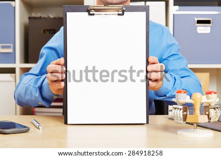 Man holding clipboard with empty piece of white paper