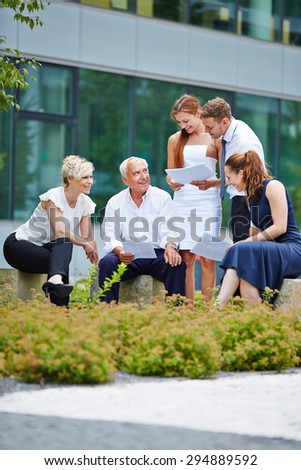 Group of business people having a meeting outdoors in summer