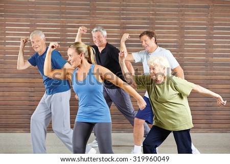 Happy senior people learning dancing in gym class