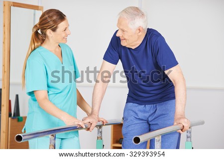 Old man exercising with physiotherapist on a horizontal bar