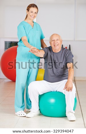 Old man doing back training in nursing home with a physiotherapist