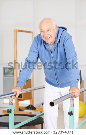 Old man standing on high bar in physiotherapy