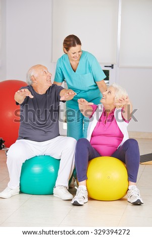 Two senior people doing fitness training in physiotherapy with physiotherapist
