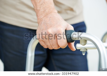 Hand of senior man on a walker in a hospital