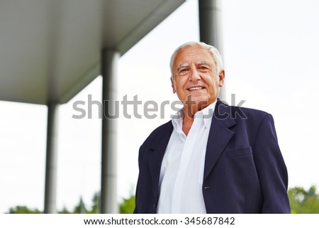 Happy old senior business man smiling outdoors