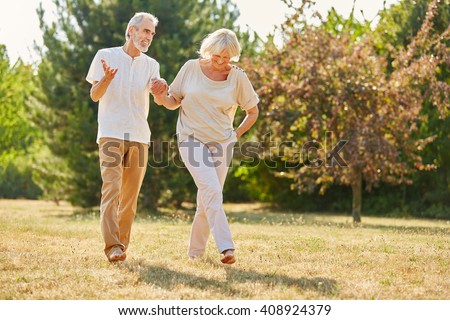 Couple in love holding hands on a walk in the park in summer