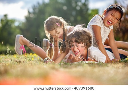 Happy children playing and having fun in summer