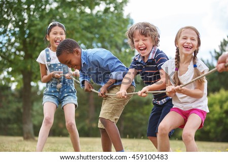 Children playing tug of war at the park