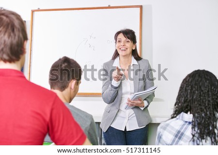 Teacher points a student with her finger at a high school class