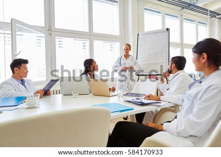Doctors in flipchart presentation at medical training seminar