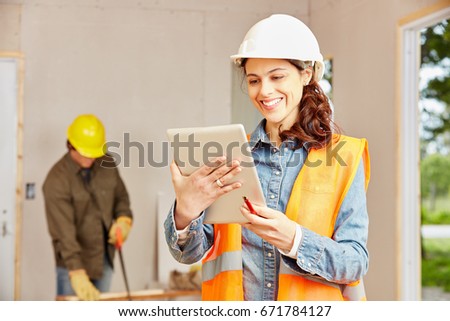 Woman with tablet computer as young architect planning new building