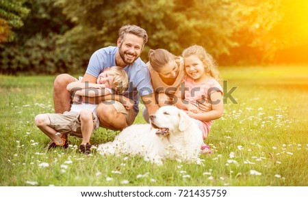 Happy family with children and dog in summer in the garden
