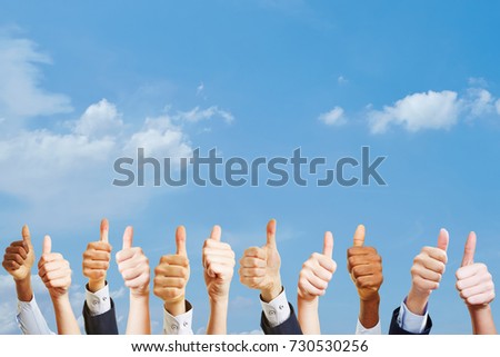 Many hands holding thumbs up as motivation at work concept