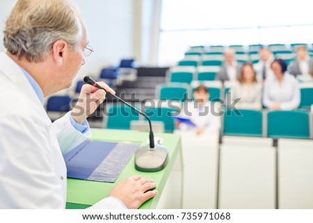 Professor giving medicine lecture to doctors for training in lecture hall