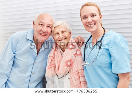 Nurse and happy senior couple in hospital or nursing home