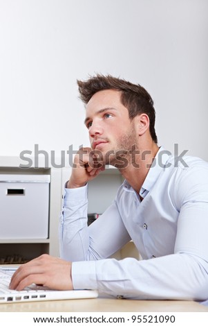 University student at laptop with writer\'s block whilw working on final thesis