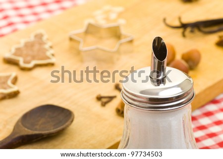 Sugar shaker and christmas cookies with different ingredients