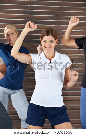 Happy dance instructor in dancing class for senior citizens