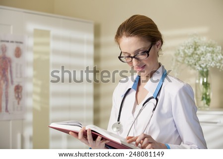 Young beautiful doctor with book