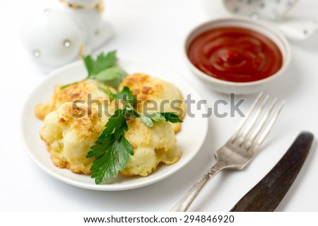 Delicious cauliflower fried in egg with herbs and tomato sauce and a fork