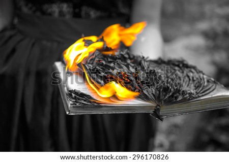 Abstract background - black burning book in women\'s hands
