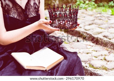 Toned picture with a sitting woman holds a book