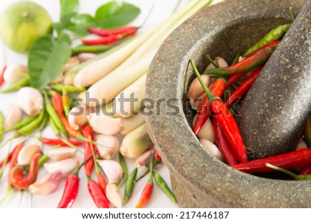Mortar with thai spices and herb (garlic, chili pepper, lemon grass, kaffir lime leaf)