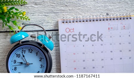 October 2018 calendar with retro clock on white wooden background. Autumn time and mood