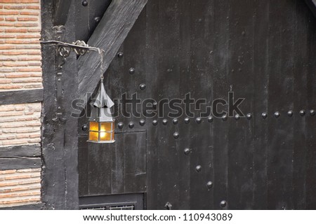 Lamp at a old black door