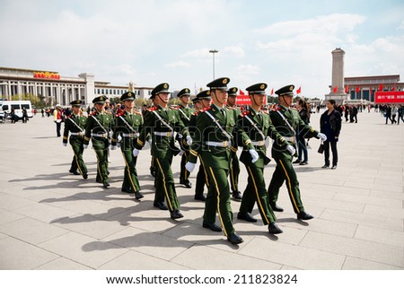 BEIJING, CHINA - APRIL 10: The Chinese soldiers march at Tiananmen Square on April 10, 2013. The Monument to the People\'s Heroes is located behind the march.