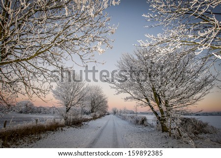 Country Lane Covered In Snow Sunset