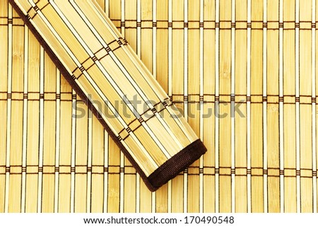 Rolled bamboo mat on a bamboo mat