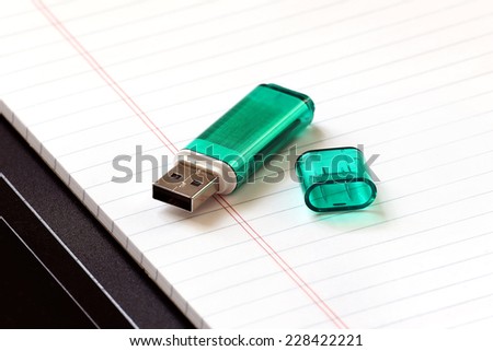 Green memory stick on notepad