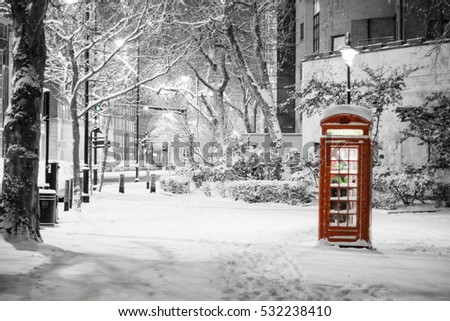 London Snow: Pretty snow scene of traditional red telephone box, The Embankment, City of Westminster, London, UK